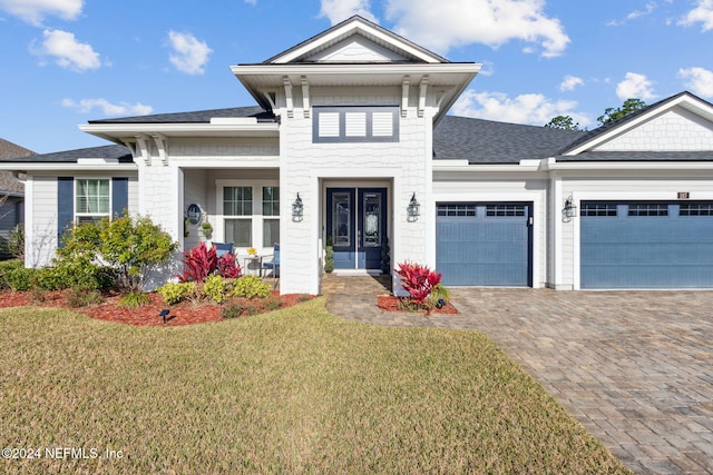 view of front of home featuring a garage and a front lawn