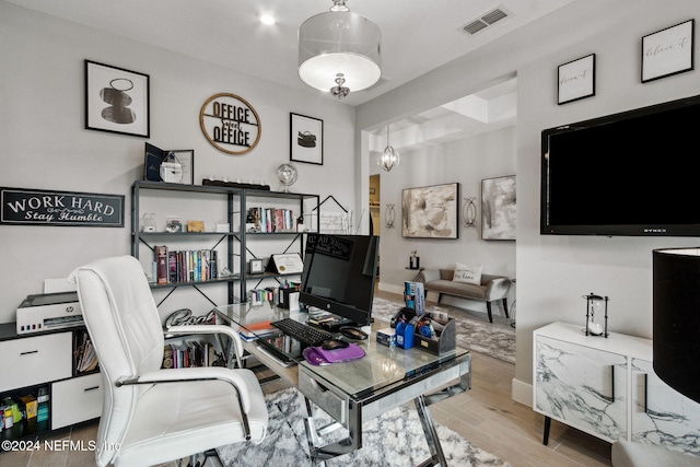 home office featuring a chandelier and light wood-type flooring