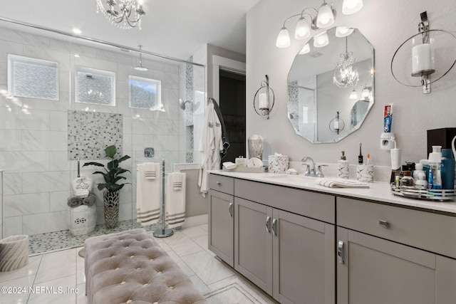 bathroom with vanity, a notable chandelier, and tiled shower