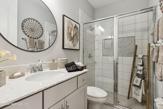 bathroom with vanity, toilet, and walk in shower