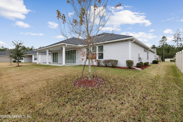 rear view of house featuring a yard, ceiling fan, and a patio area