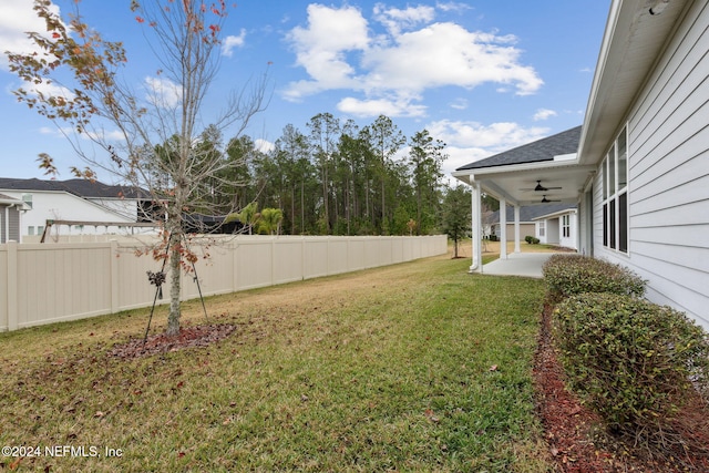 view of yard featuring ceiling fan and a patio area