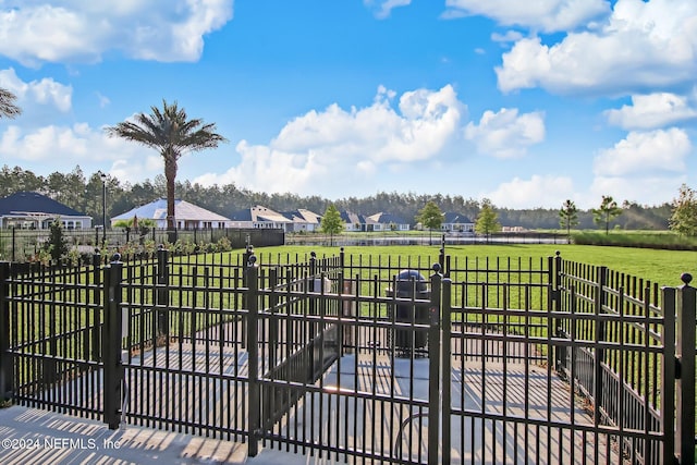 view of gate with a yard