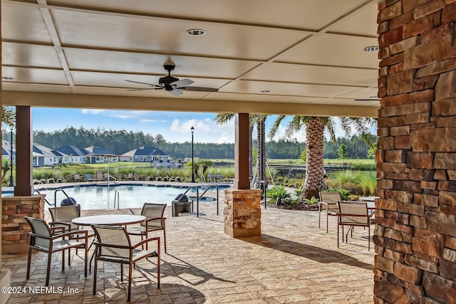 view of patio / terrace featuring a community pool and ceiling fan