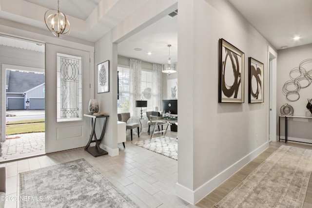 foyer featuring a chandelier