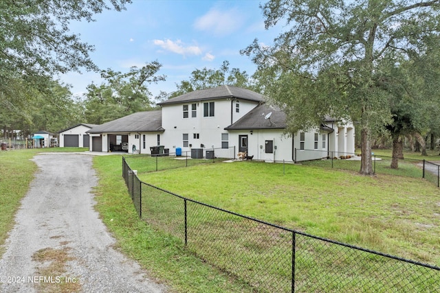 rear view of property with a yard and a garage