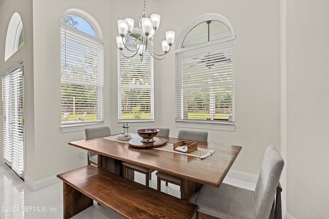 tiled dining space with an inviting chandelier