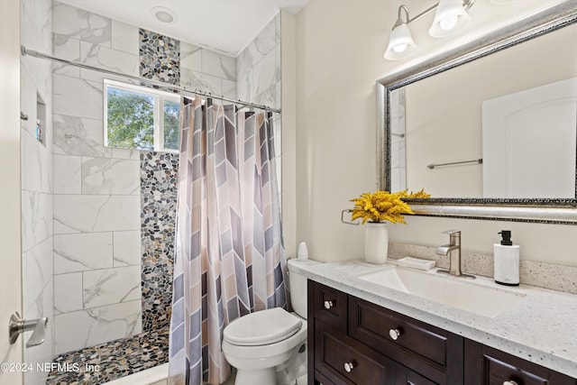 bathroom with a shower with curtain, vanity, and toilet