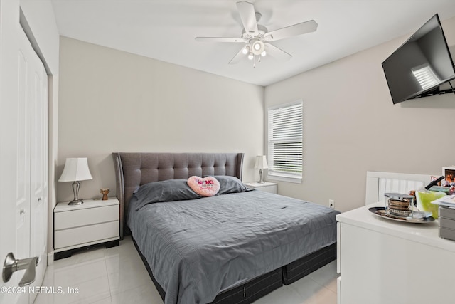 bedroom with light tile patterned flooring, a closet, and ceiling fan