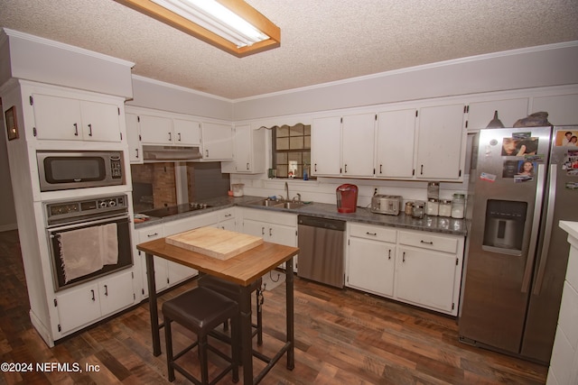 kitchen with white cabinetry, sink, dark wood-type flooring, crown molding, and black appliances