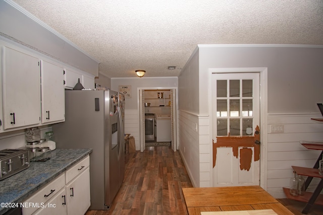 kitchen featuring a textured ceiling, dark hardwood / wood-style flooring, white cabinetry, and washer / dryer