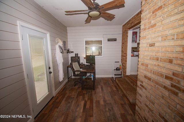 hall with dark wood-type flooring and wood walls