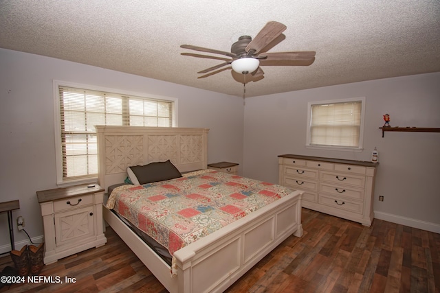 bedroom with a textured ceiling, dark hardwood / wood-style flooring, and ceiling fan