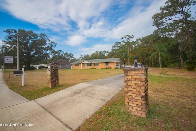 bungalow-style house with a front lawn