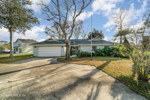 ranch-style home with a front yard and a garage