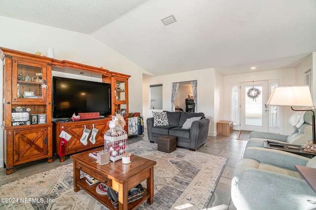 living room with a textured ceiling, radiator, and lofted ceiling