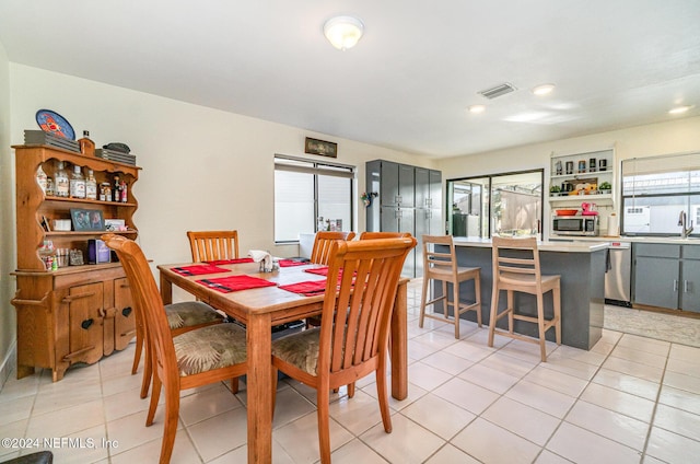 dining area with light tile patterned floors and sink