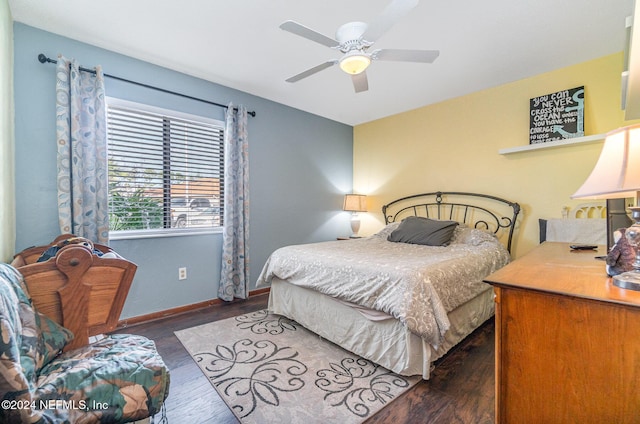 bedroom with dark hardwood / wood-style flooring and ceiling fan