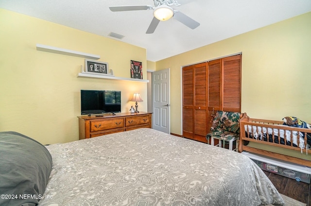 bedroom featuring ceiling fan, a closet, and wood-type flooring