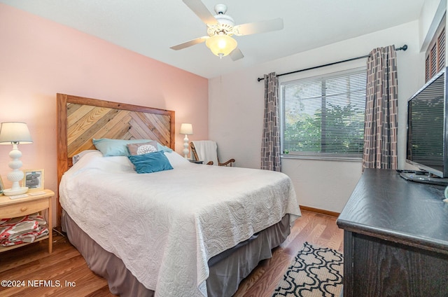 bedroom with ceiling fan and wood-type flooring