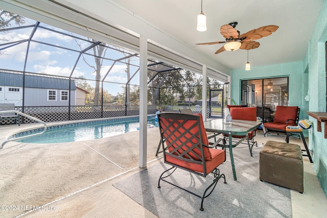 view of pool featuring a patio area, ceiling fan, and a lanai