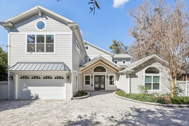 front of property with a garage and french doors