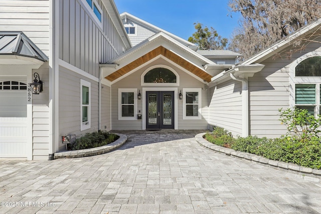 property entrance with french doors and a garage