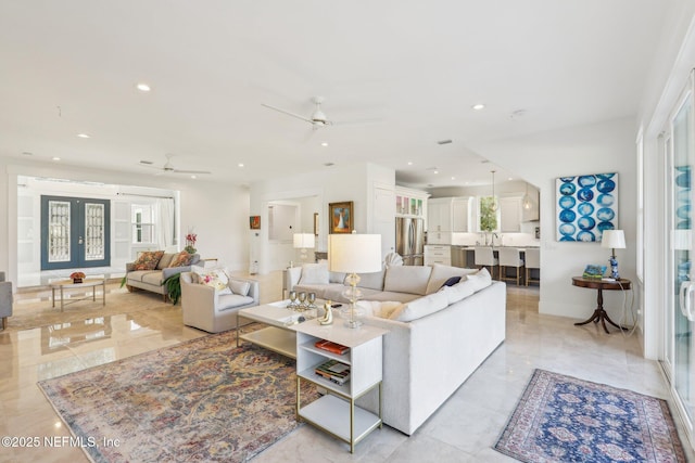 living room with french doors and ceiling fan