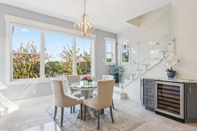 dining area with wine cooler and a chandelier