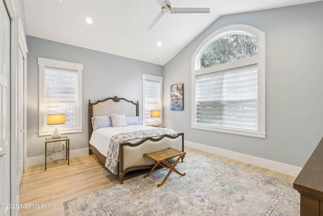 bedroom featuring lofted ceiling, ceiling fan, and light hardwood / wood-style flooring