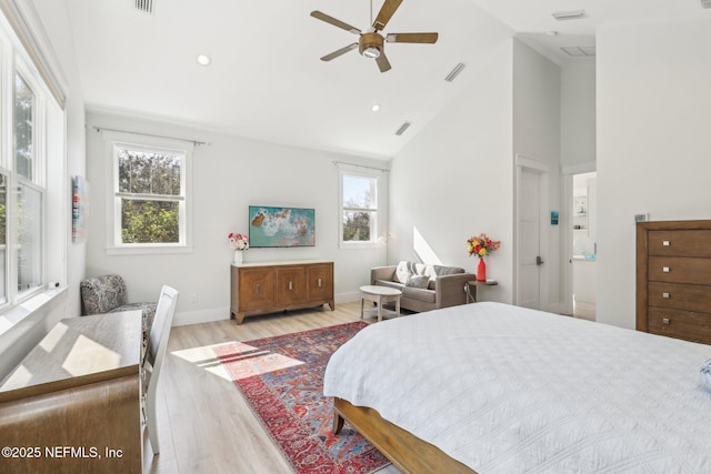 bedroom with ceiling fan, high vaulted ceiling, and light wood-type flooring