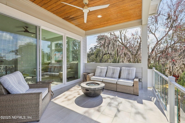 sunroom / solarium with wood ceiling and ceiling fan