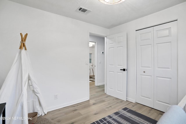 bedroom featuring a closet and light hardwood / wood-style floors