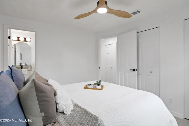 bedroom featuring ceiling fan and two closets