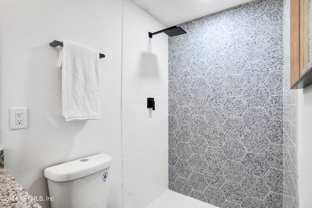 bathroom featuring toilet and tiled shower