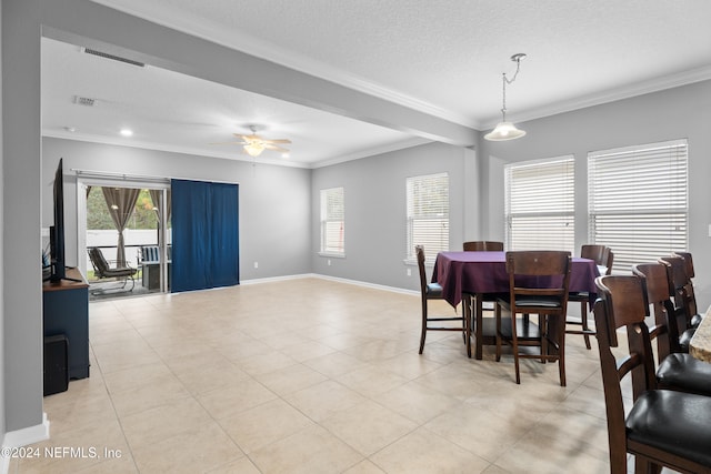 tiled dining room with a textured ceiling, ceiling fan, and ornamental molding