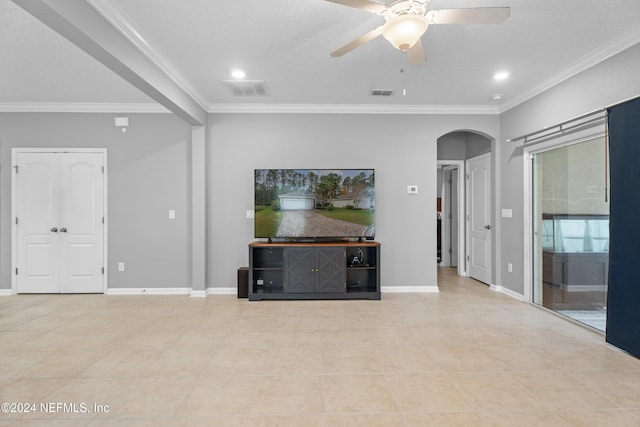 unfurnished living room featuring ceiling fan, light tile patterned floors, a textured ceiling, and ornamental molding