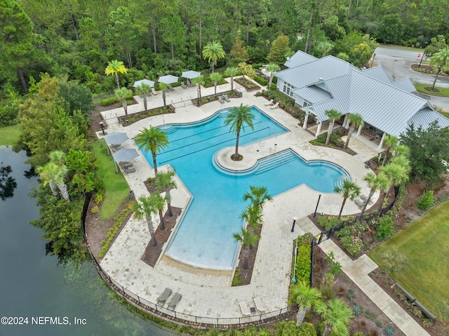 view of pool featuring a water view