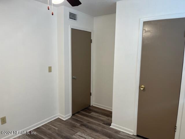 corridor featuring dark wood-type flooring