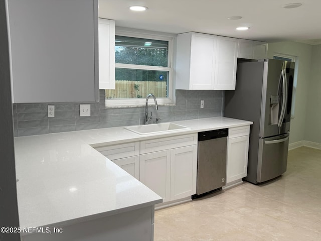 kitchen featuring white cabinets, sink, light tile patterned floors, appliances with stainless steel finishes, and tasteful backsplash