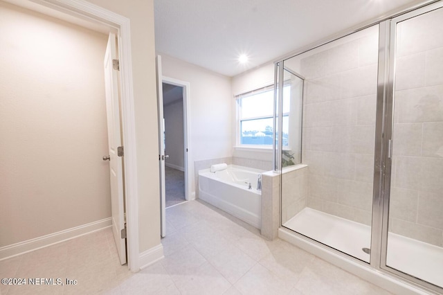 bathroom with tile patterned flooring and separate shower and tub