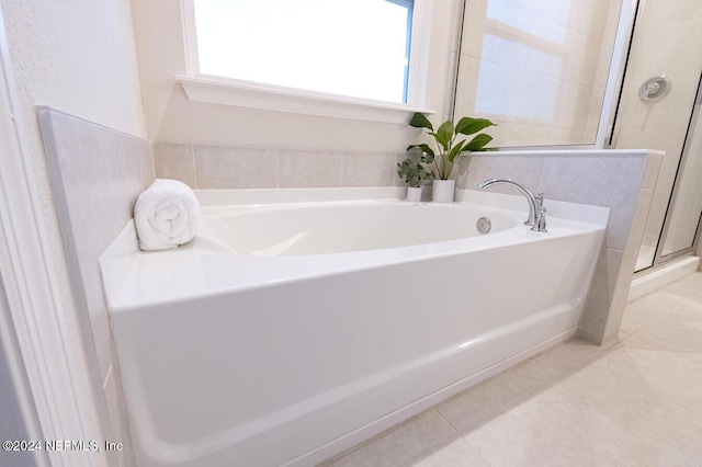 bathroom featuring tile patterned flooring and separate shower and tub