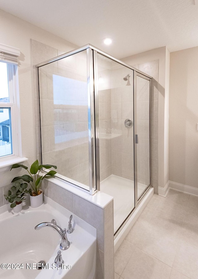 bathroom featuring tile patterned floors, sink, and plus walk in shower