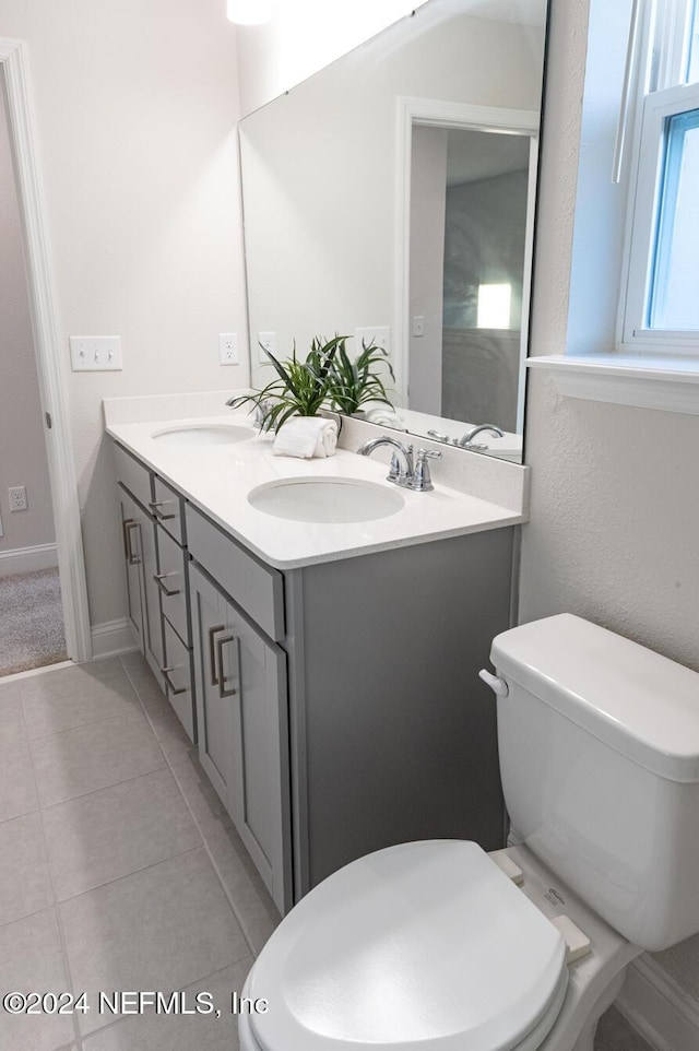 bathroom featuring tile patterned floors, vanity, and toilet