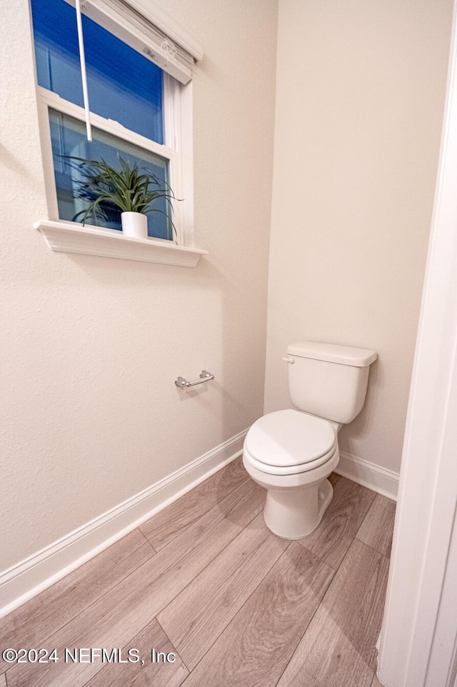 bathroom featuring hardwood / wood-style floors and toilet