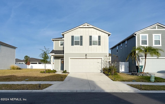 view of front of property featuring a garage and a front lawn