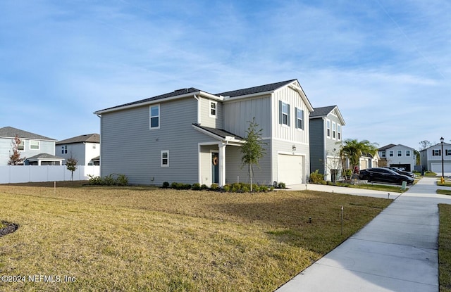 view of side of property featuring a lawn and a garage