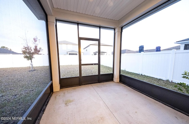 sunroom / solarium with plenty of natural light and wood ceiling