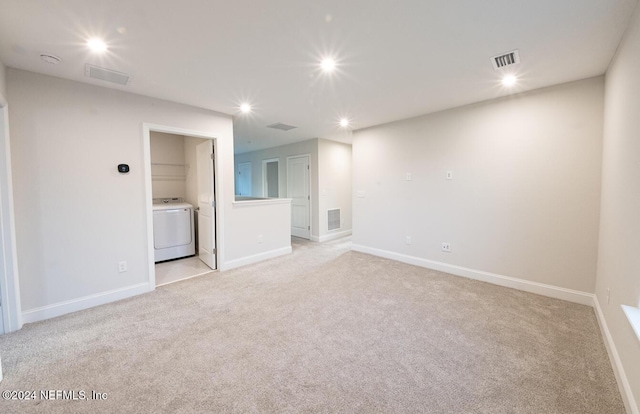 carpeted empty room featuring washer / clothes dryer