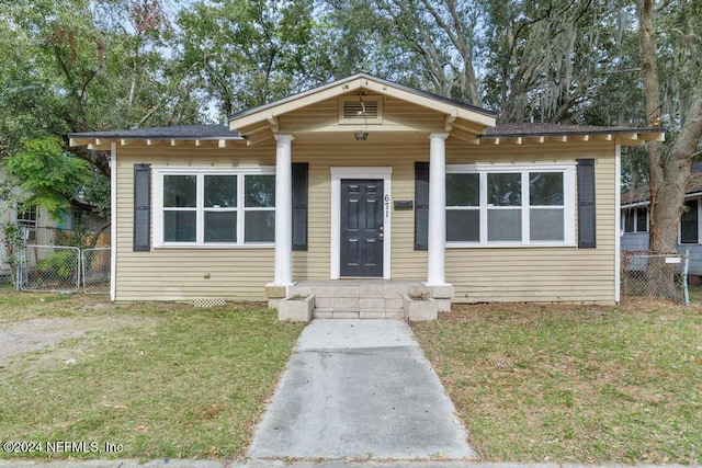 bungalow-style home with a front lawn